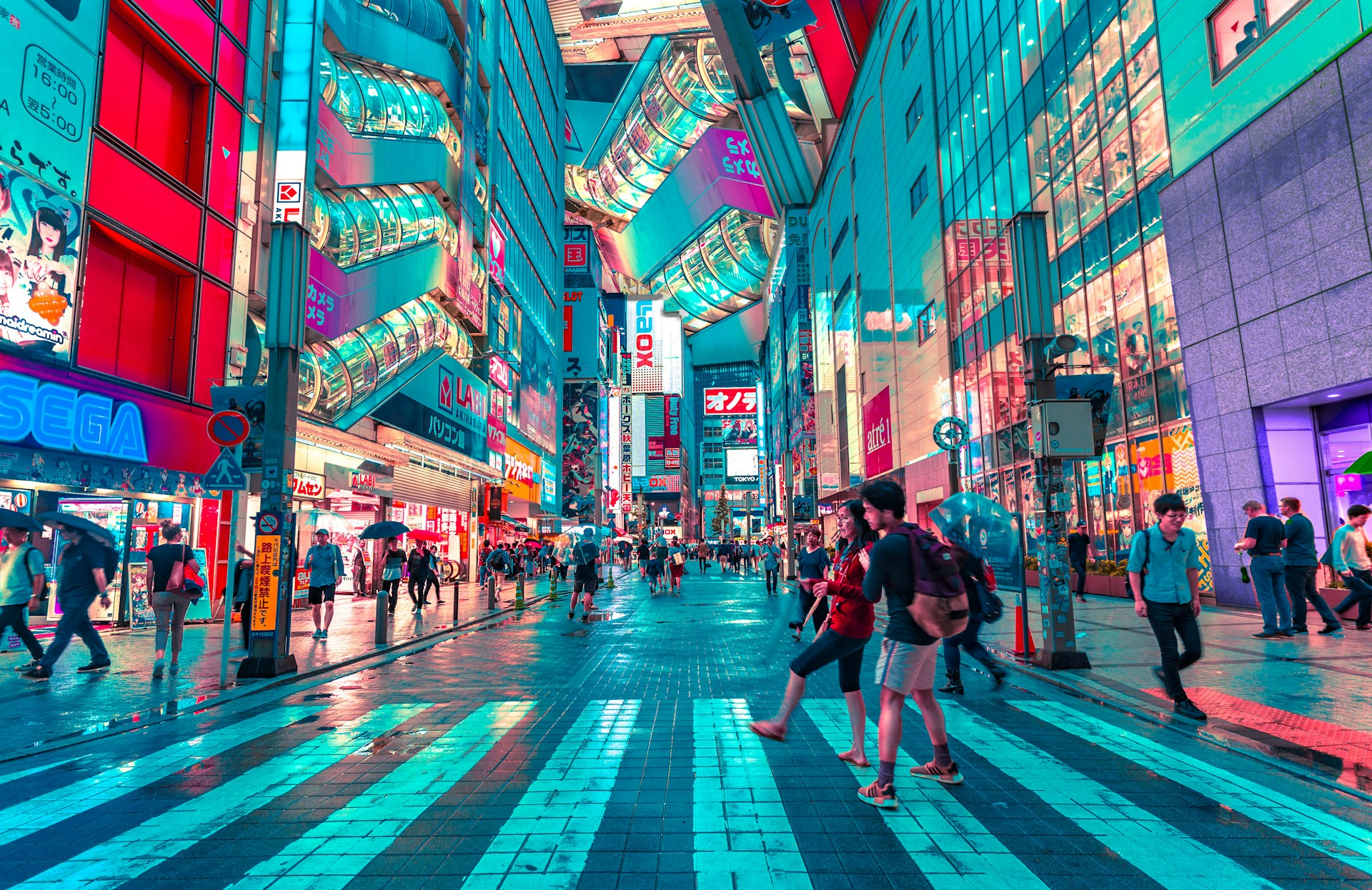 Busy pedestrian crossing in Tokyo at night with neon signs